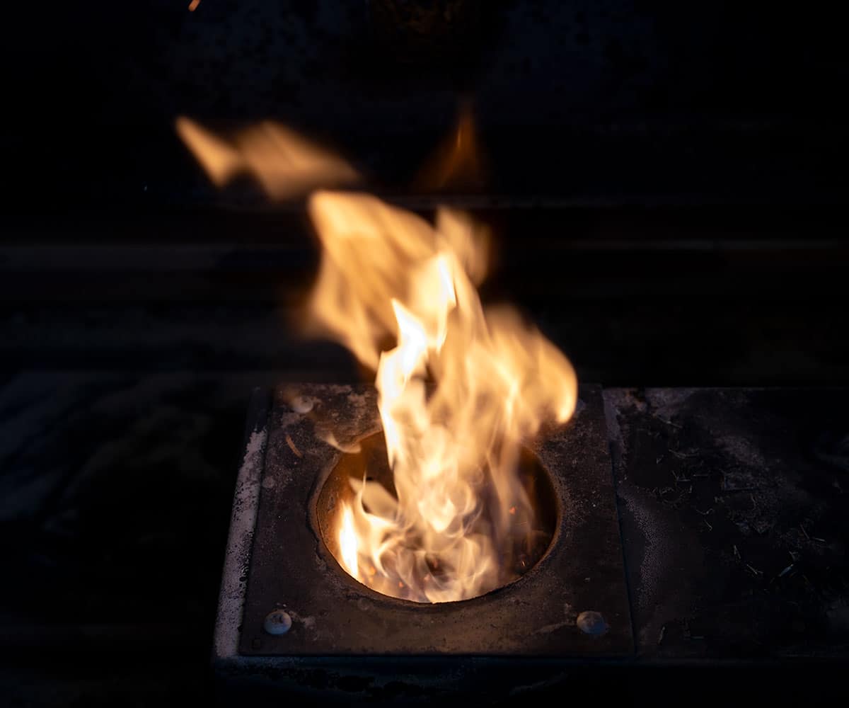 fire burning in pellet grill fire pot.