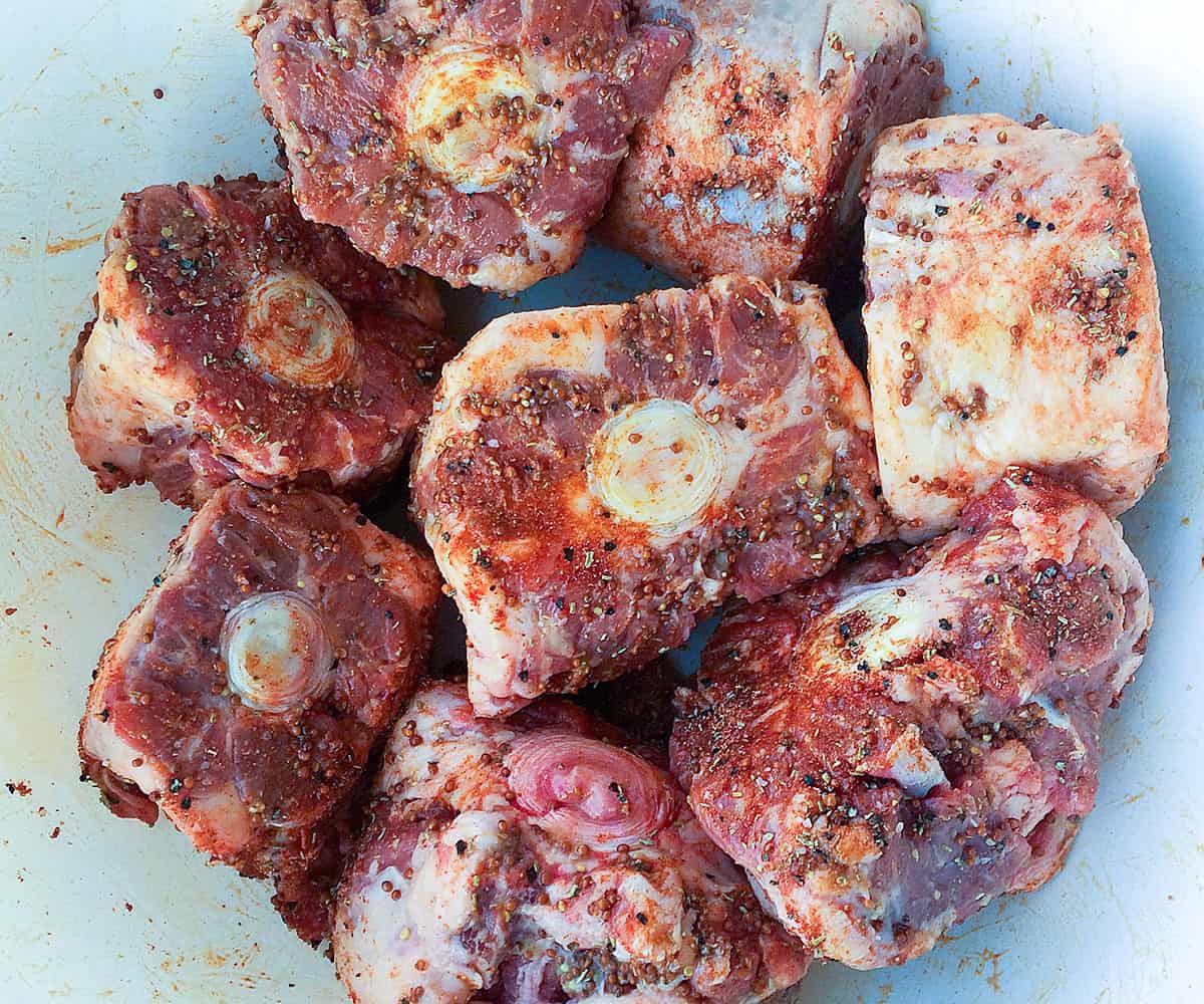oxtails rubbed with mustard and seasoning. 