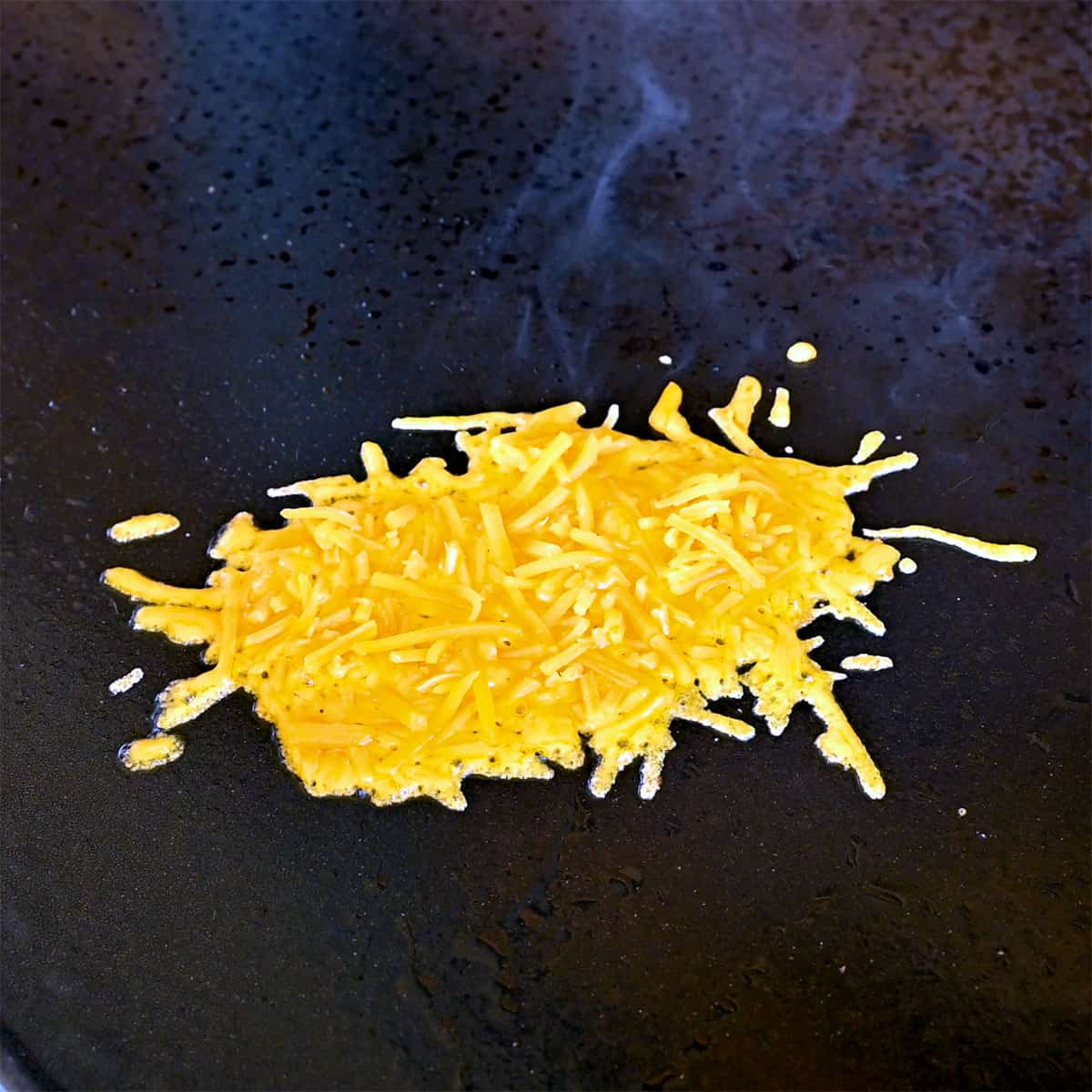 cheddar cheese on griddle.
