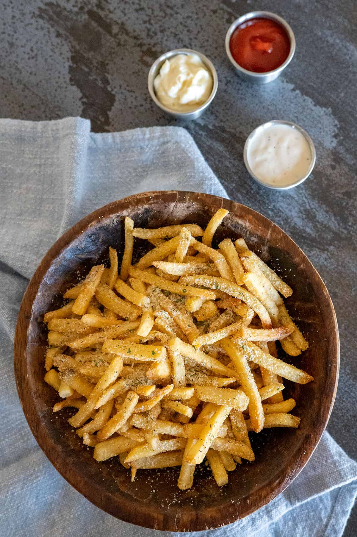 overhead shot of parmesan ranch fries with dipping sauces.