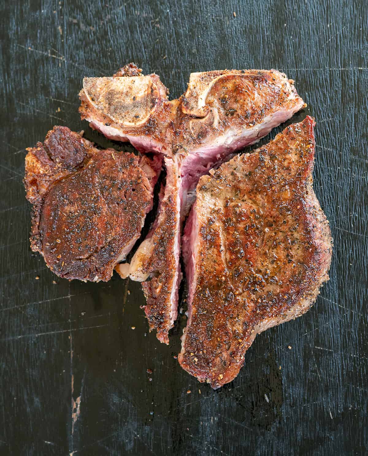 seared porterhouse, sliced so strip and filet are removed from t-bone.