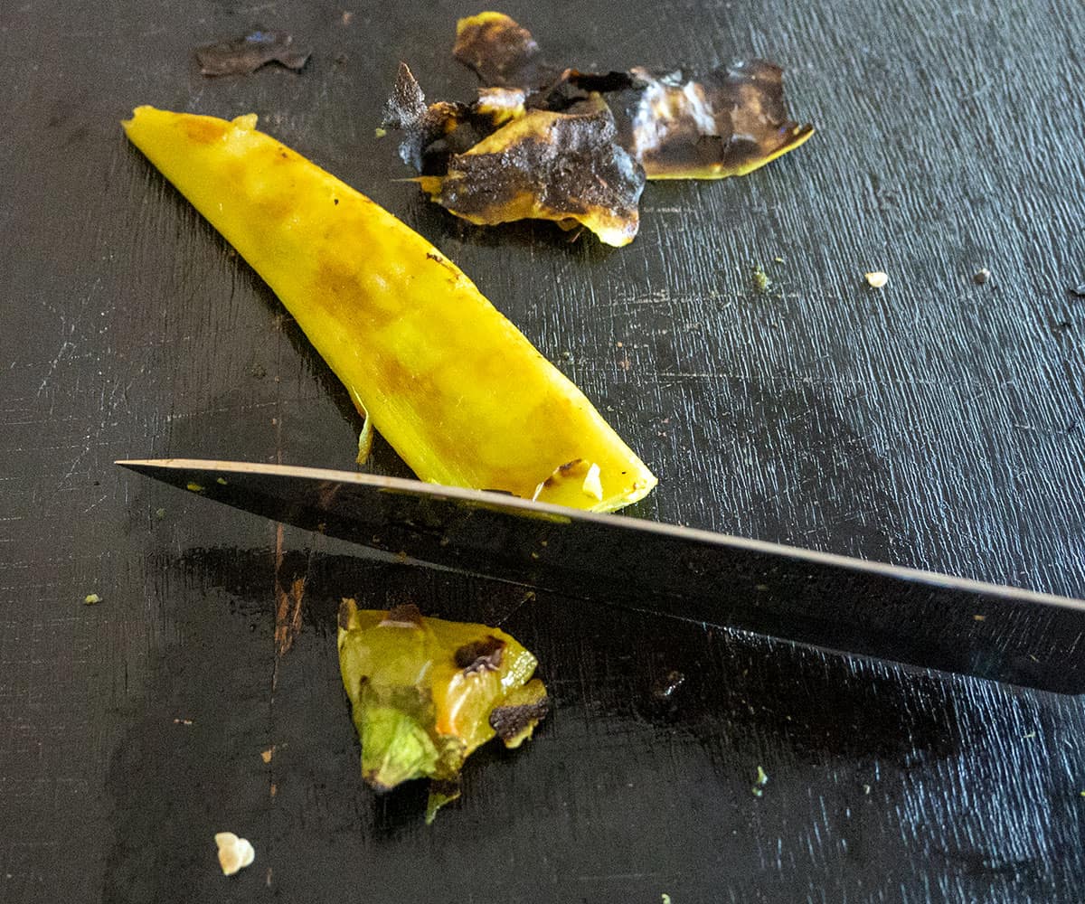 removing stem from hatch pepper.