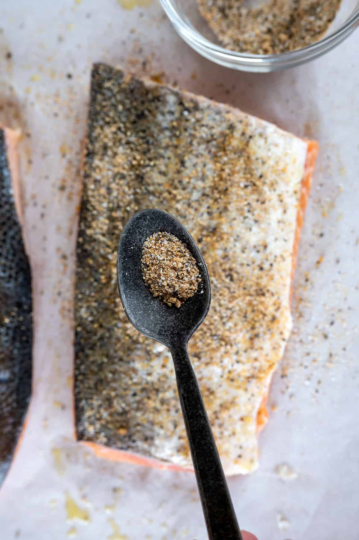 seasoning sprinkled on skin side of salmon.