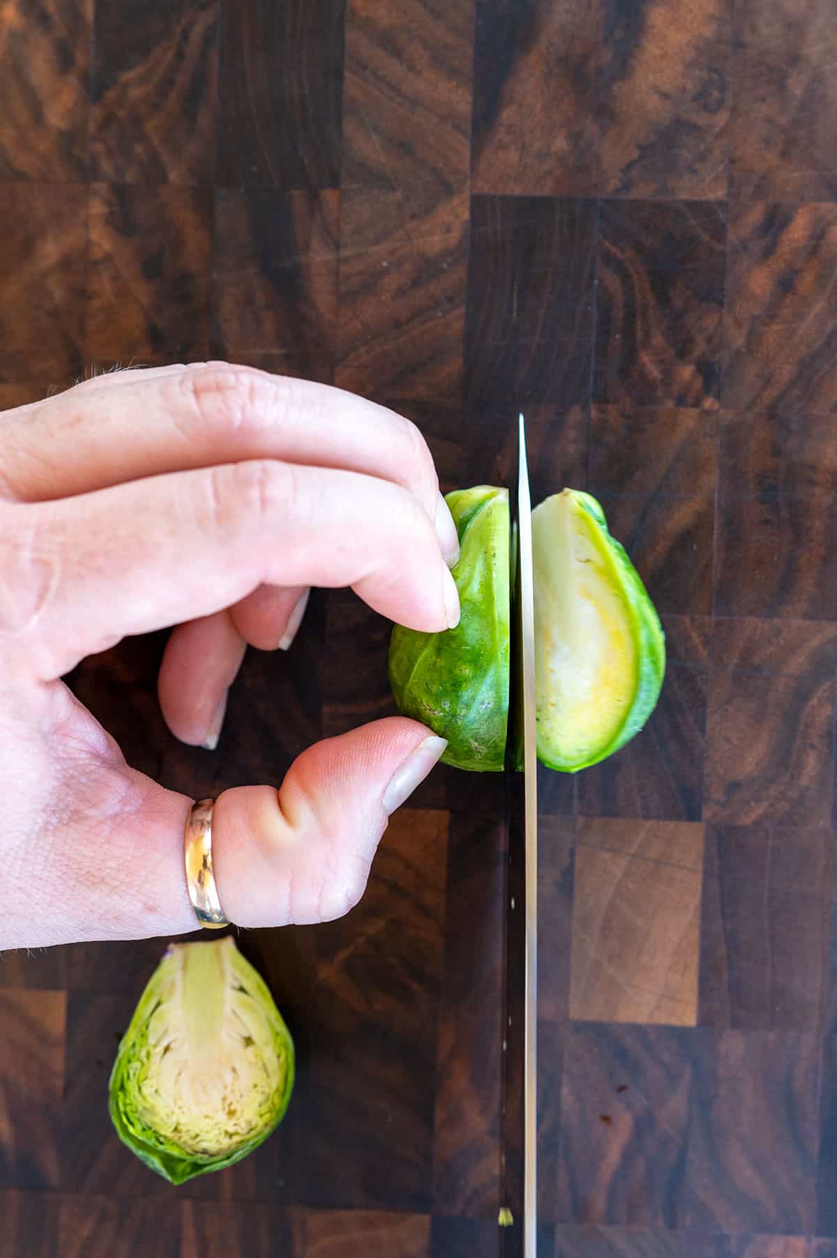 knife slicing brussels sprouts in half.
