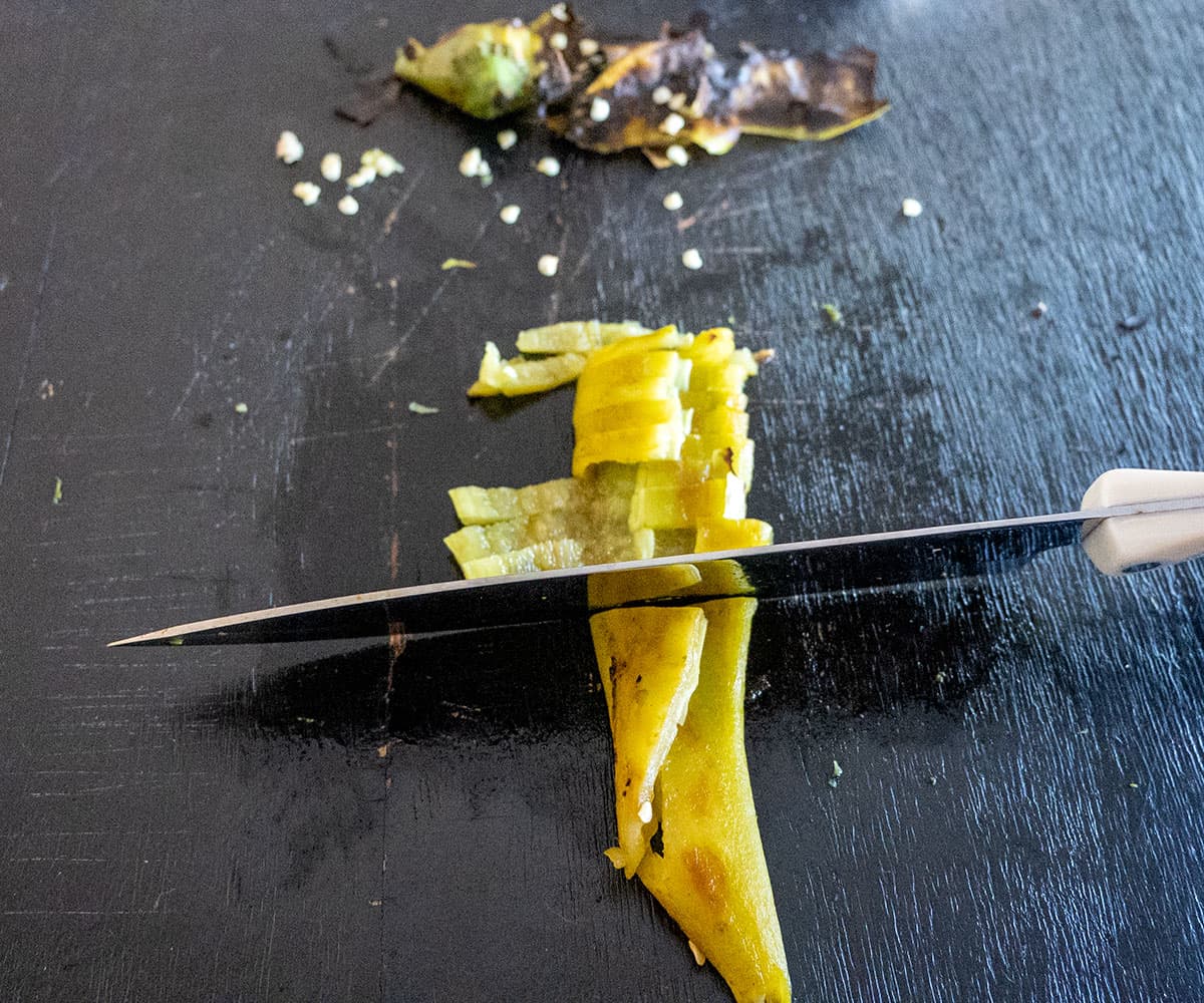 Slicing roasted hatch chile pepper.