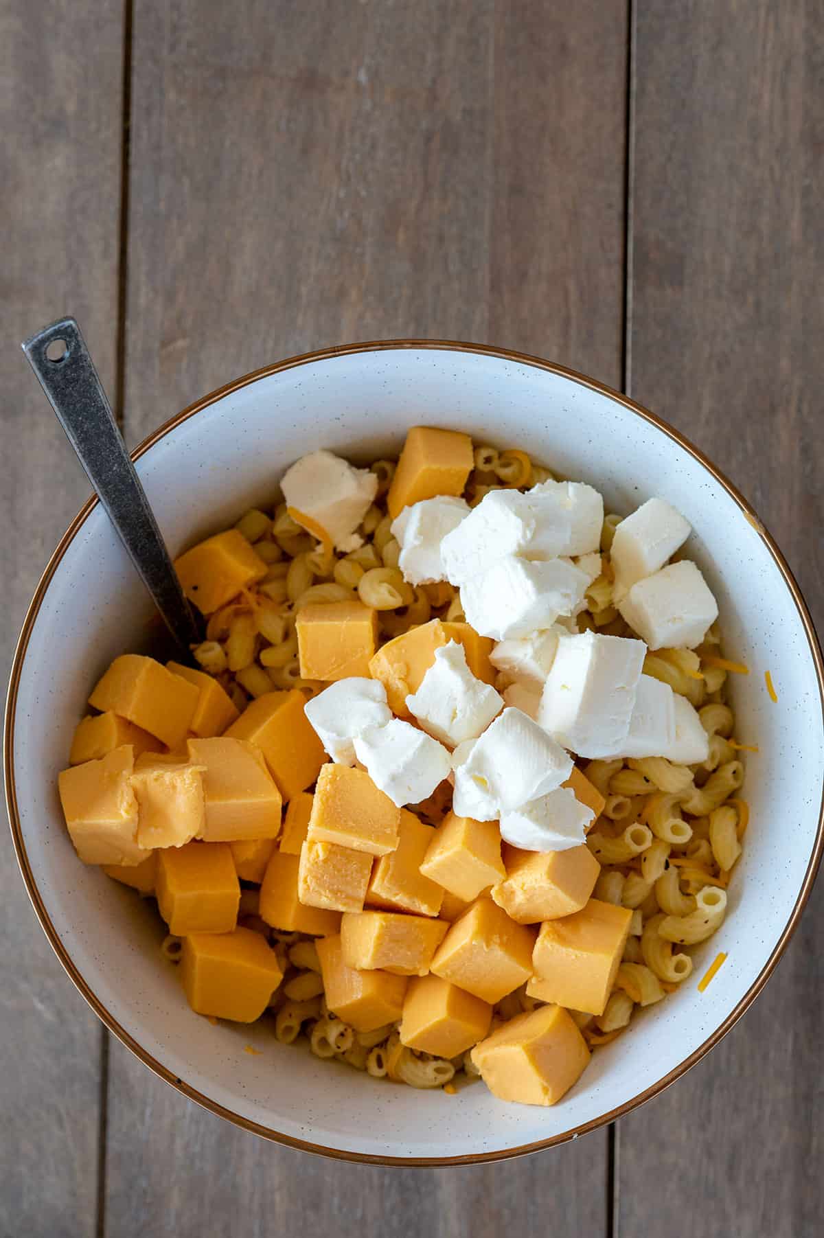 cubed cheeses on top of noodles.