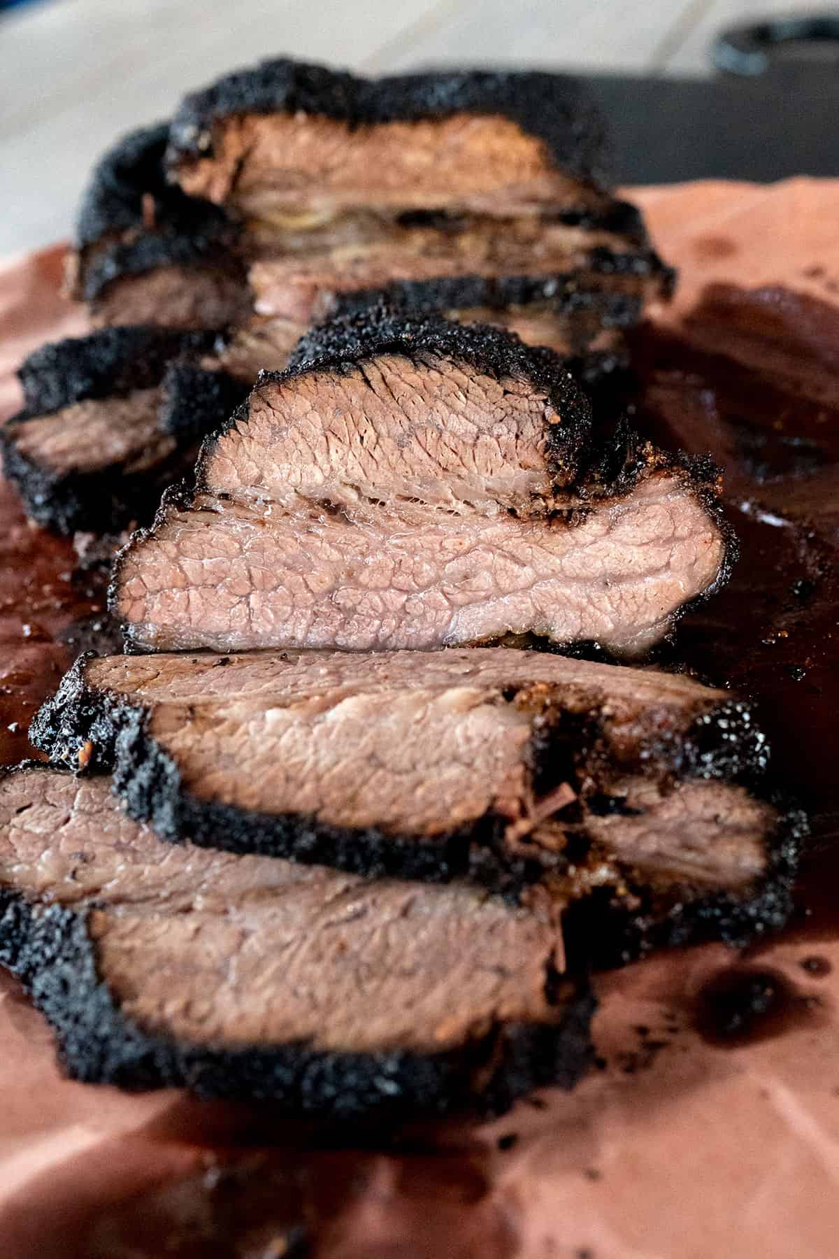 sliced smoked brisket cooked on the Ninja Woodfire Grill.