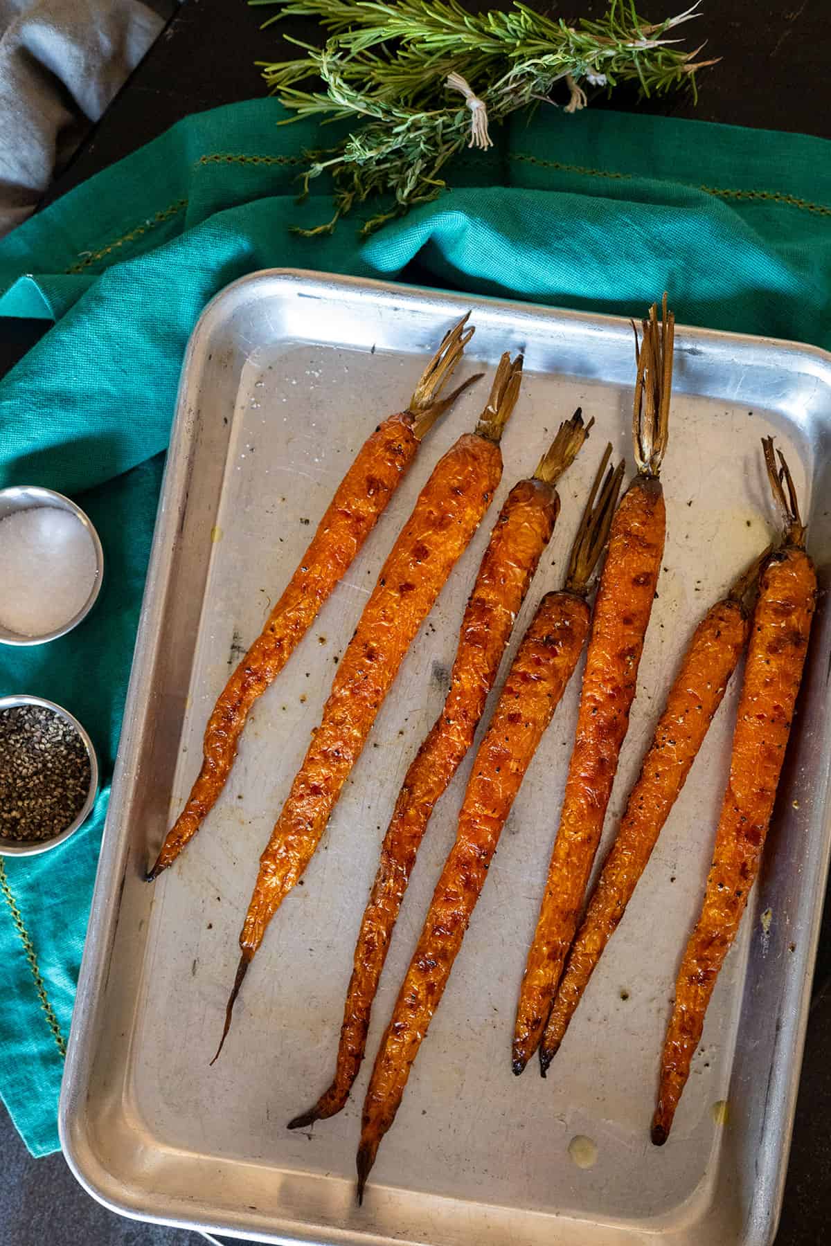 grilled carrots on pan with blue napkin.