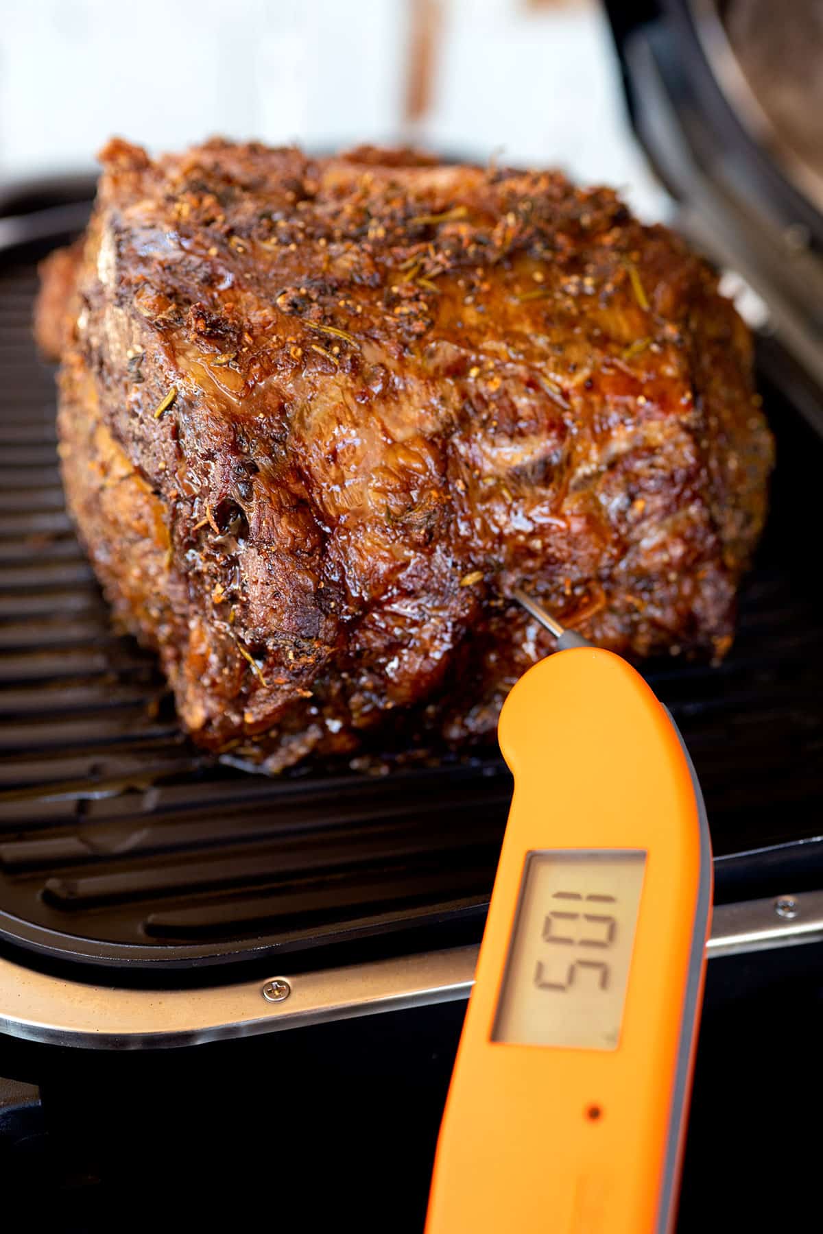 instant read thermometer in prime rib showing temperature of 105F.