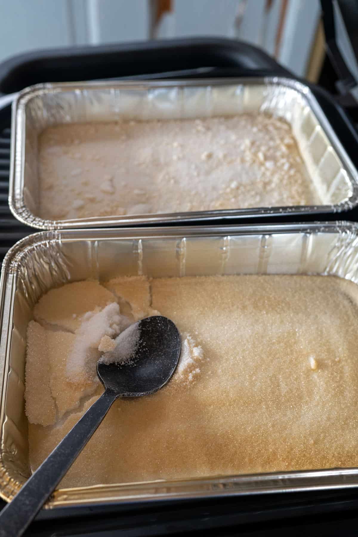 spoon cracking smoked sugar in a pan.