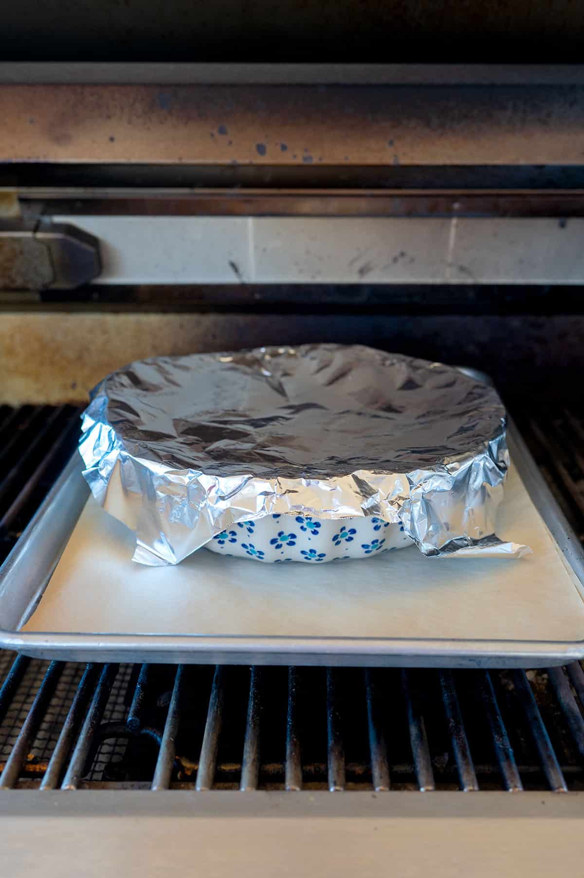 pie on sheet pan on grill covered with foil.