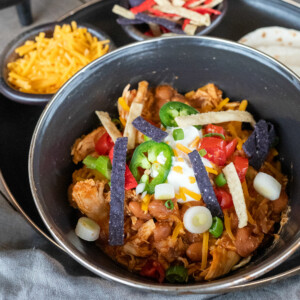 bowl of southwest chicken chili with toppings.