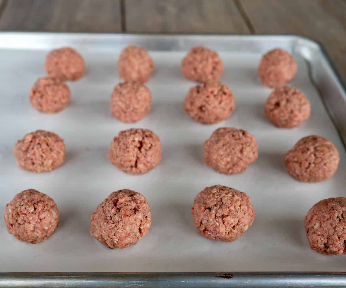 raw meatballs on sheetpan.