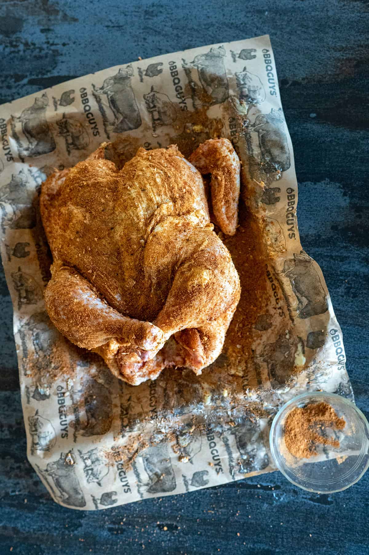 whole chicken rubbed with seasoning.