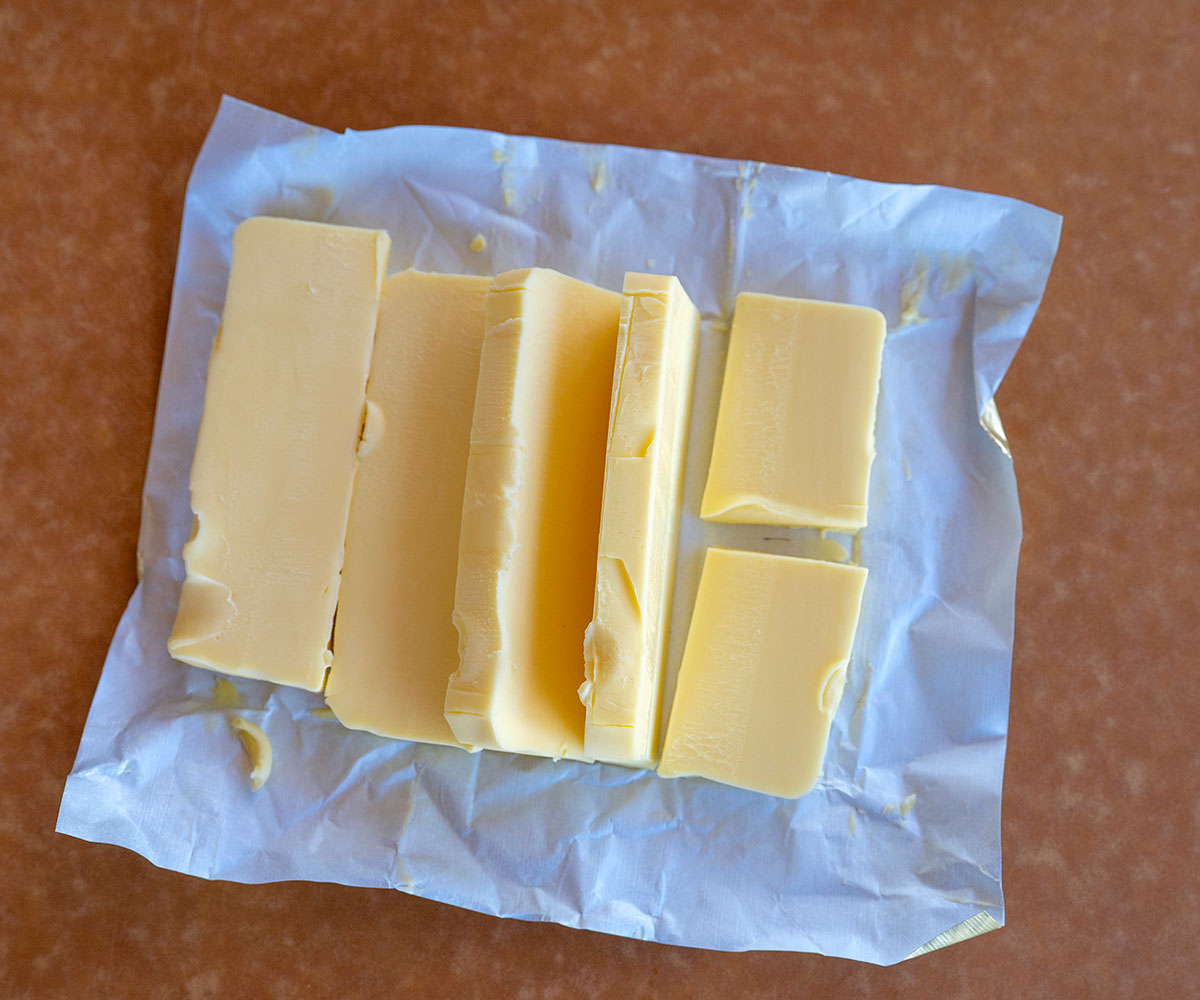 butter cut into 5 pieces and then one piece cut in half.