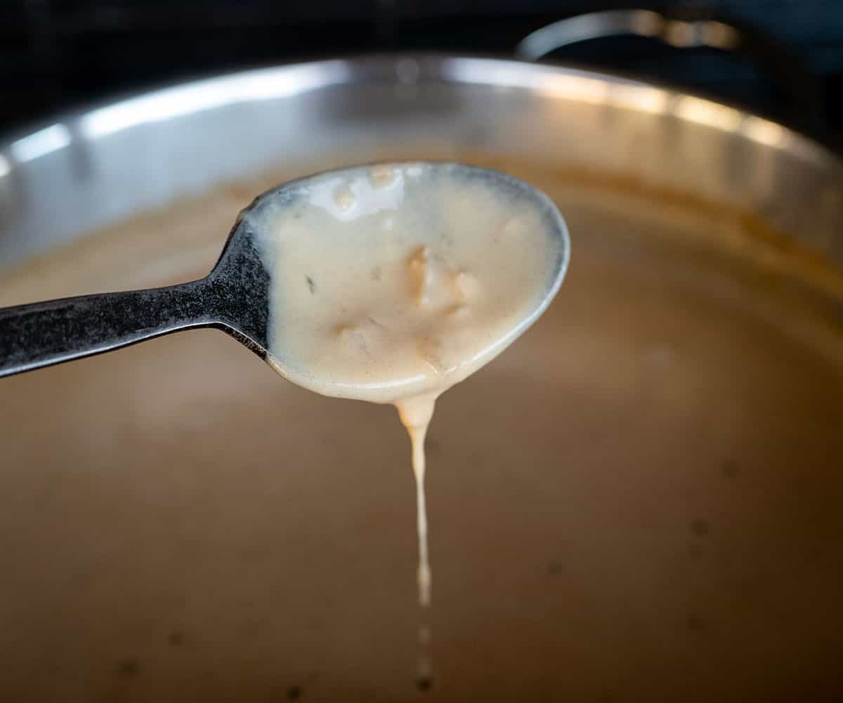 cream sauce dripping from spoon.