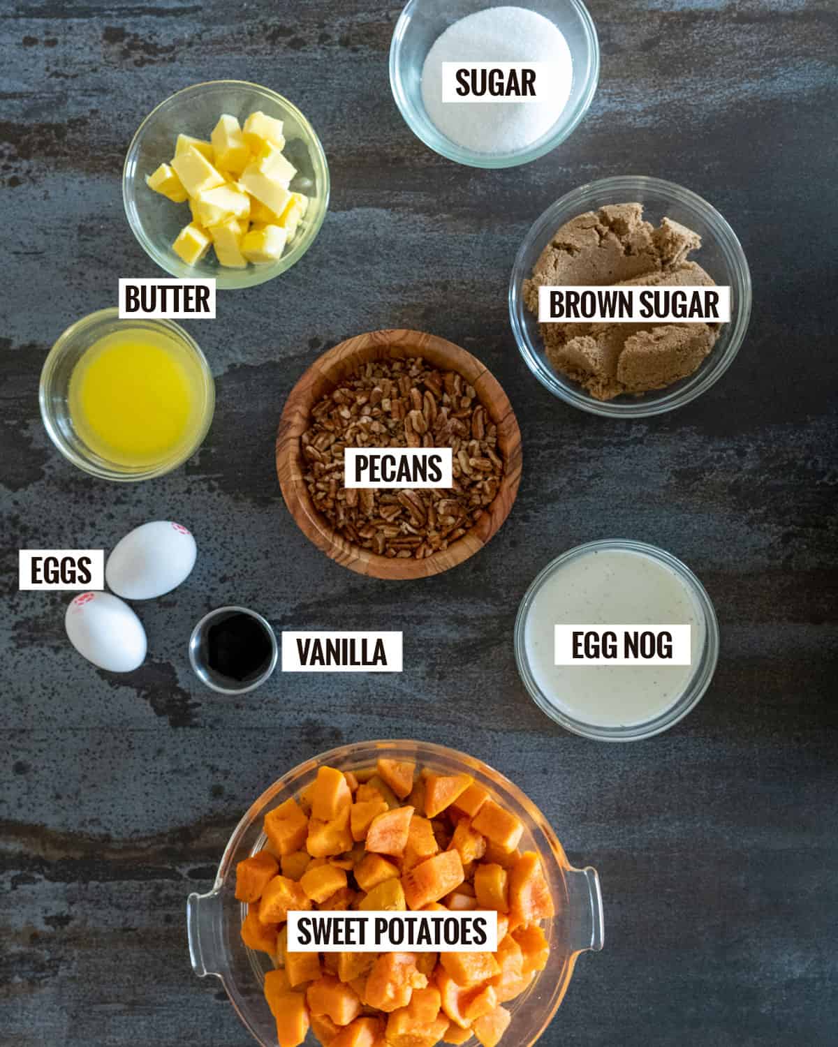 sweet potato casserole ingredients: sugar, brown sugar, pecans, butter, eggs, vanilla, egg nog, sweet potatoes. 