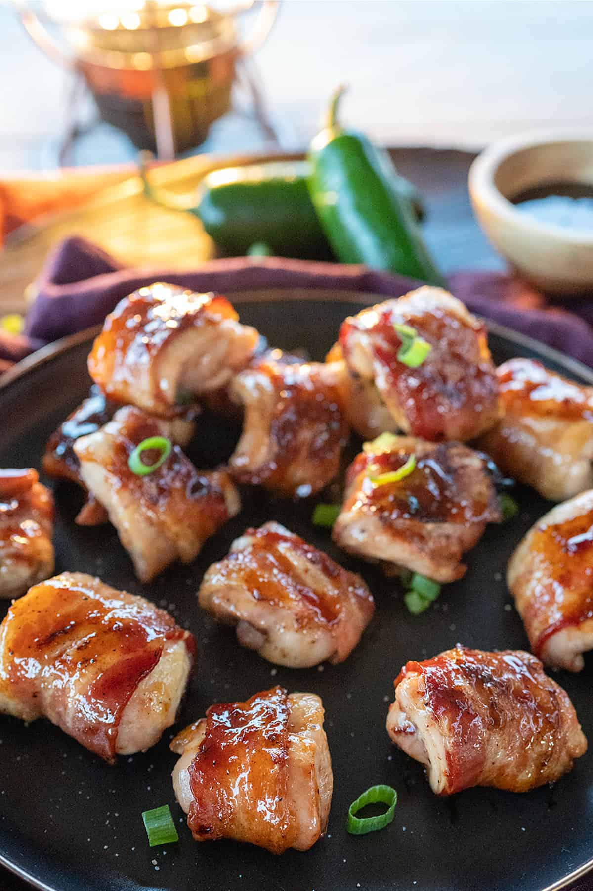 plate of bacon wrapped chicken thighs.