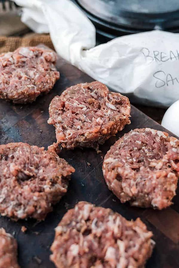 uncooked sausage patties on board.