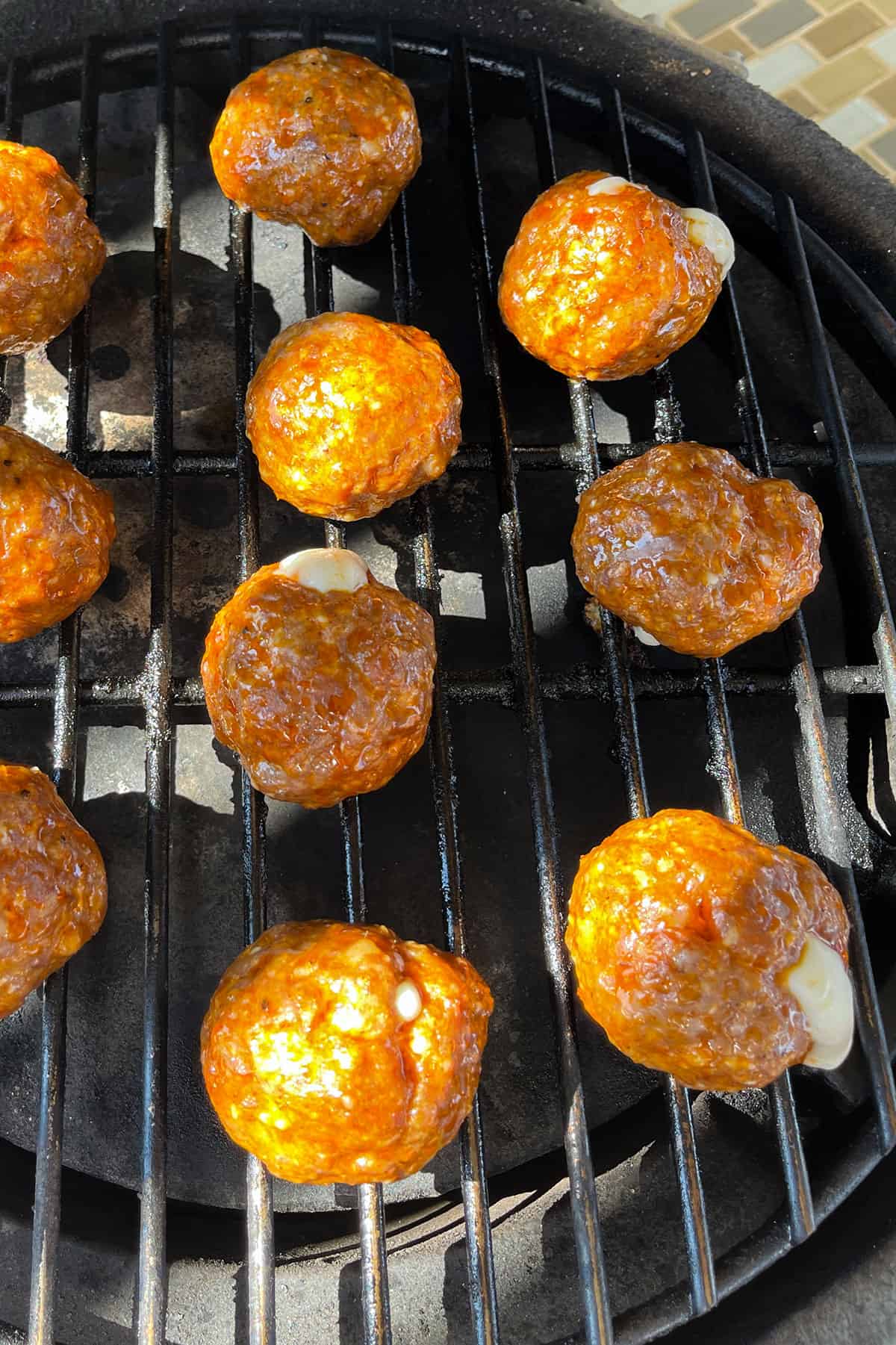 cheese oozing out of meatballs while they smoke.