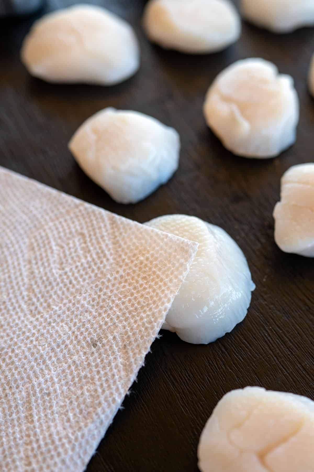patting scallops dry with a paper towel.