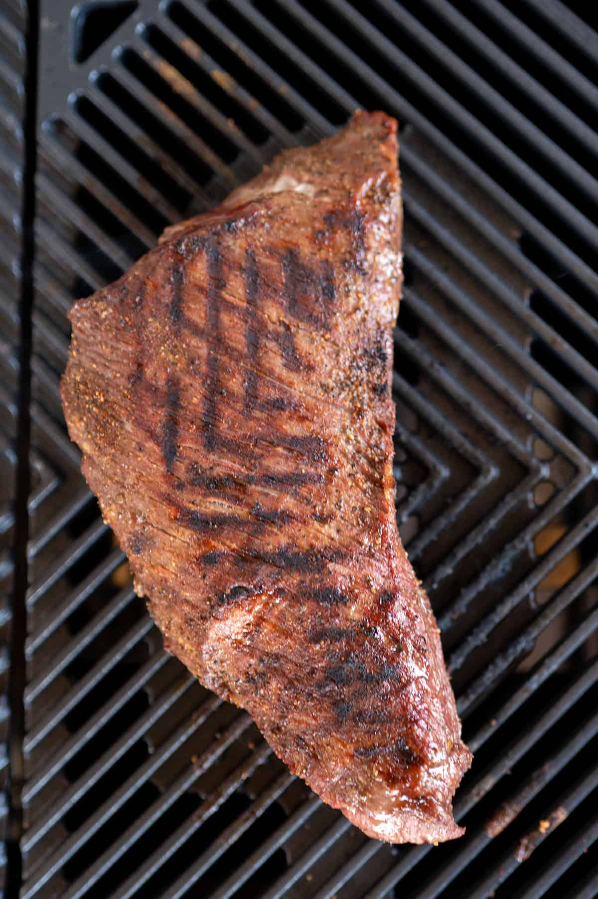 tri tip on grill with grill marks.