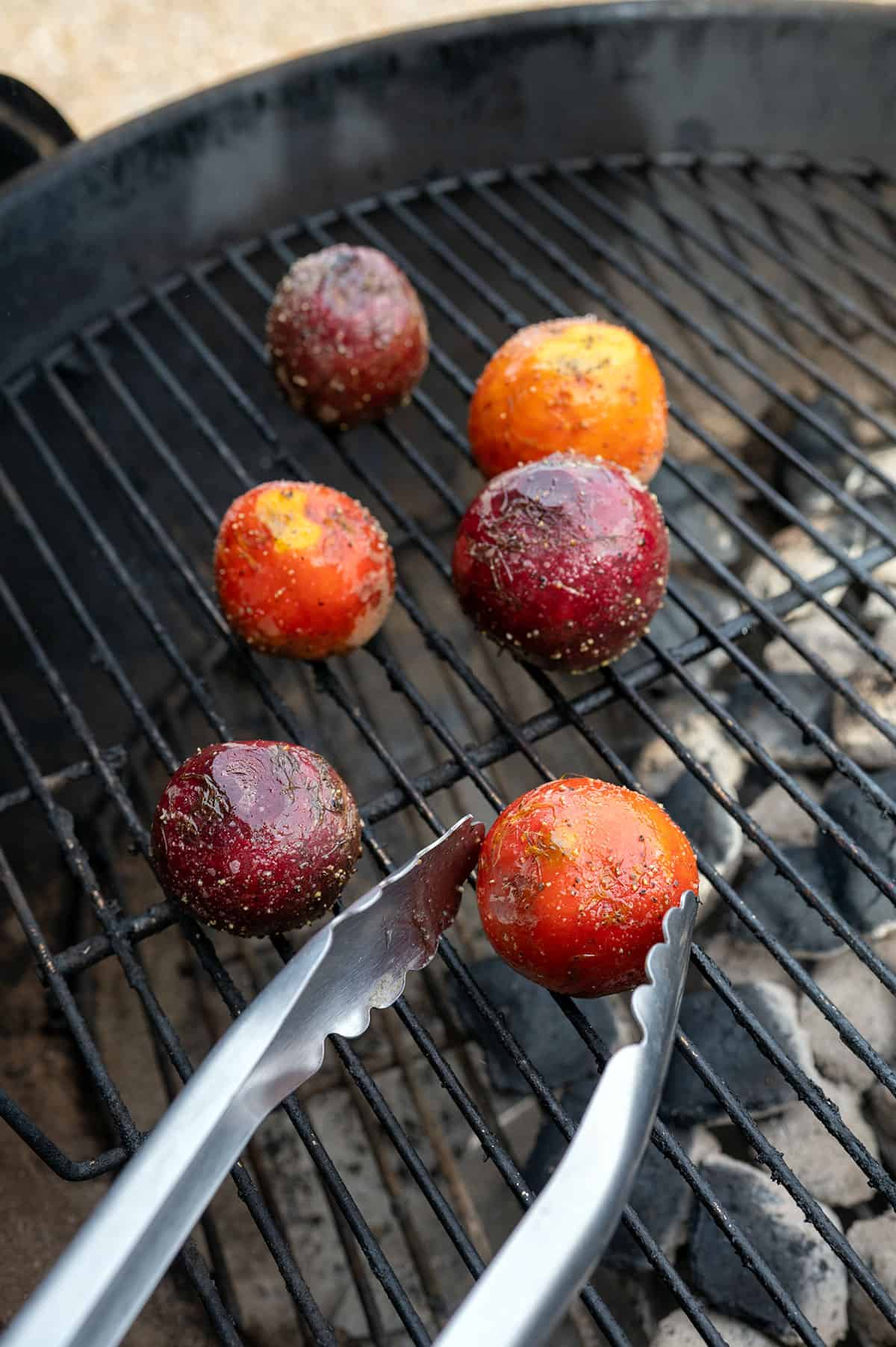 placing seasoned beets on grill.