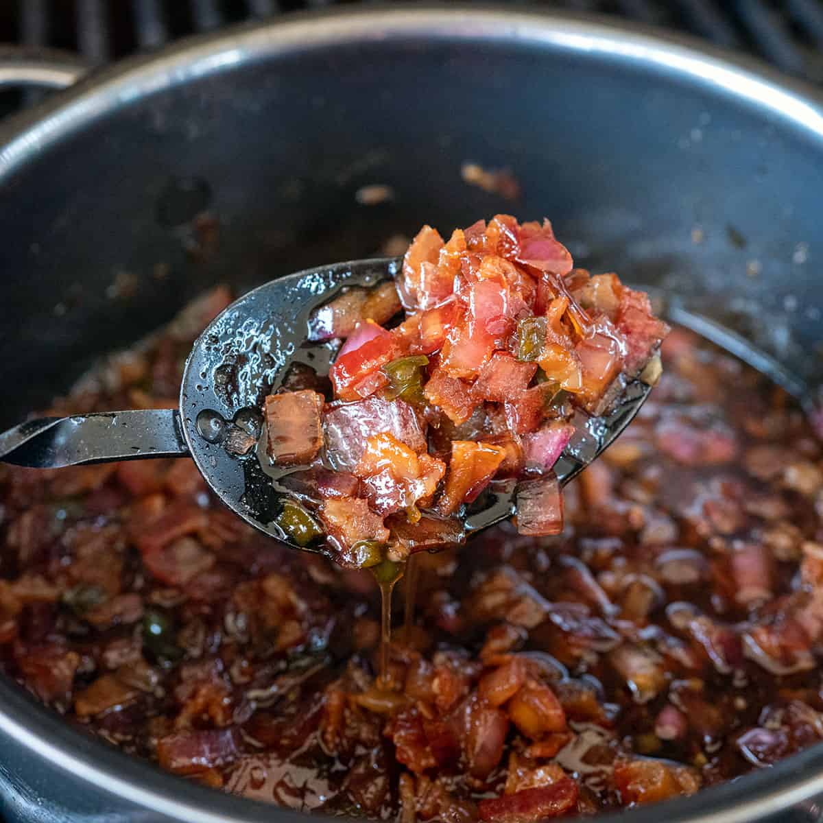 spoonful of bacon jam over pot.