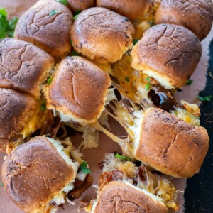 pulled pork sliders pulled apart with cheese pull.