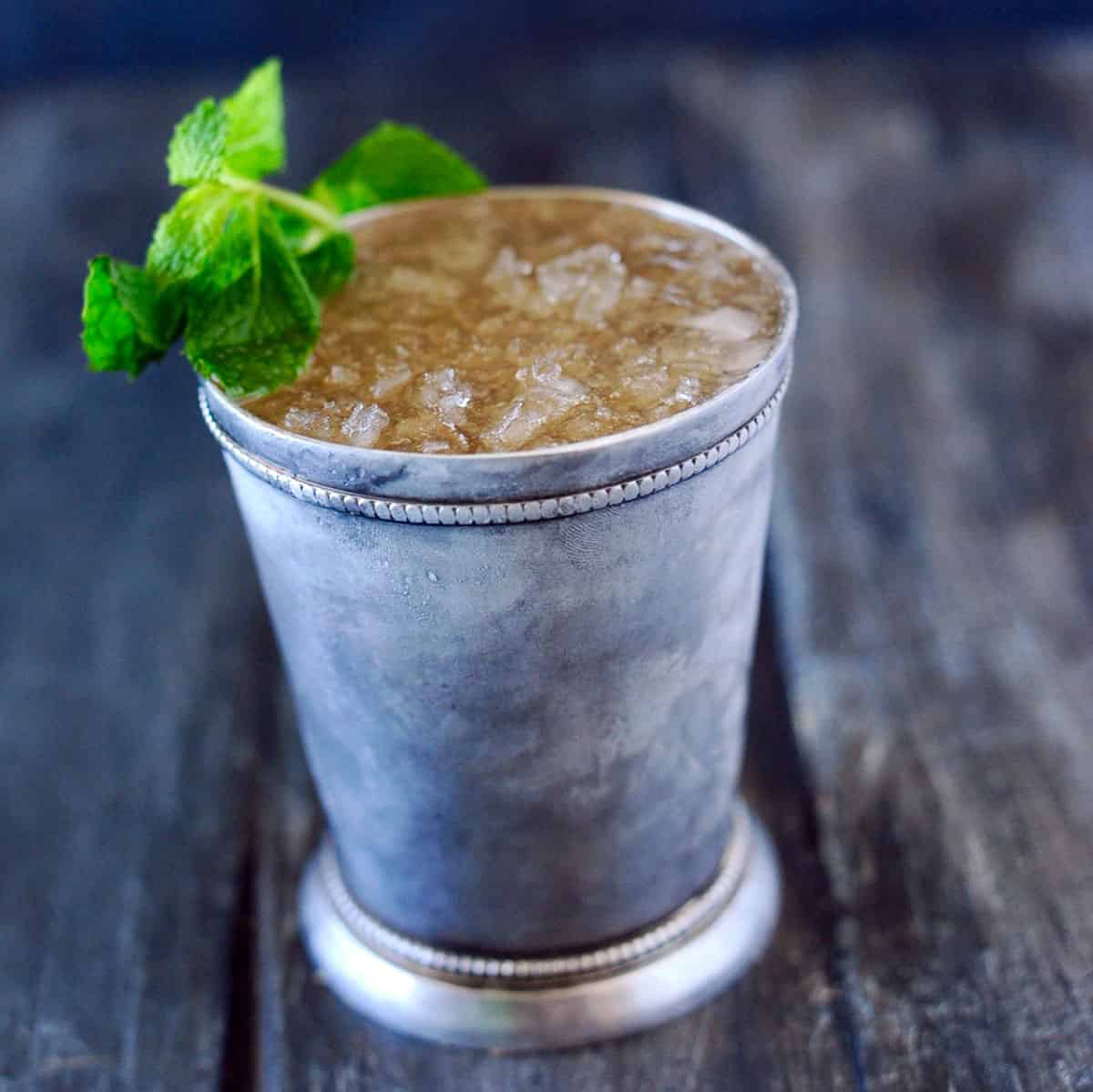 smoked mint julep in silver cup with mint sprig.
