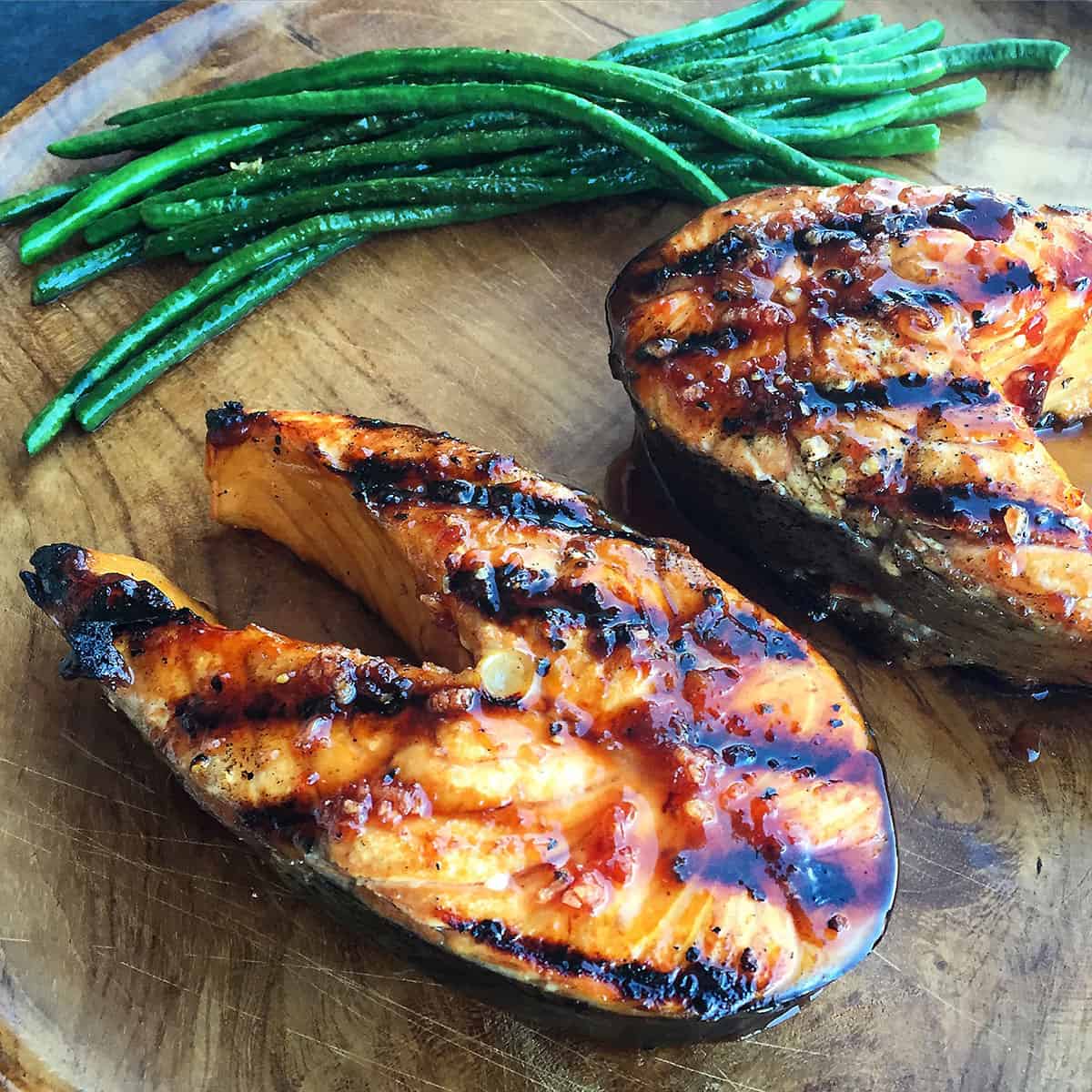 grilled salmon with cherry glaze near green beans.