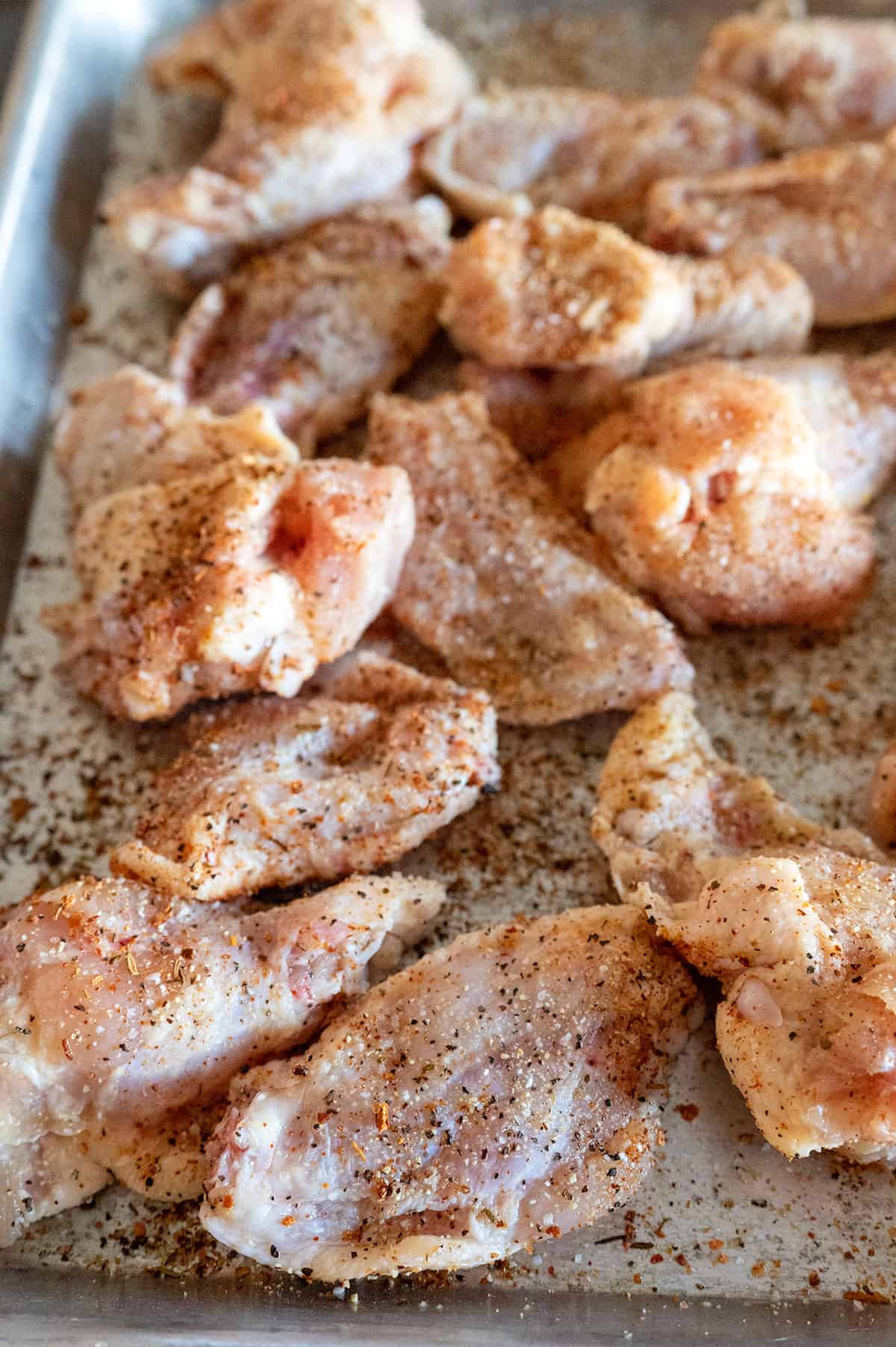 seasoned chicken wings on tray.