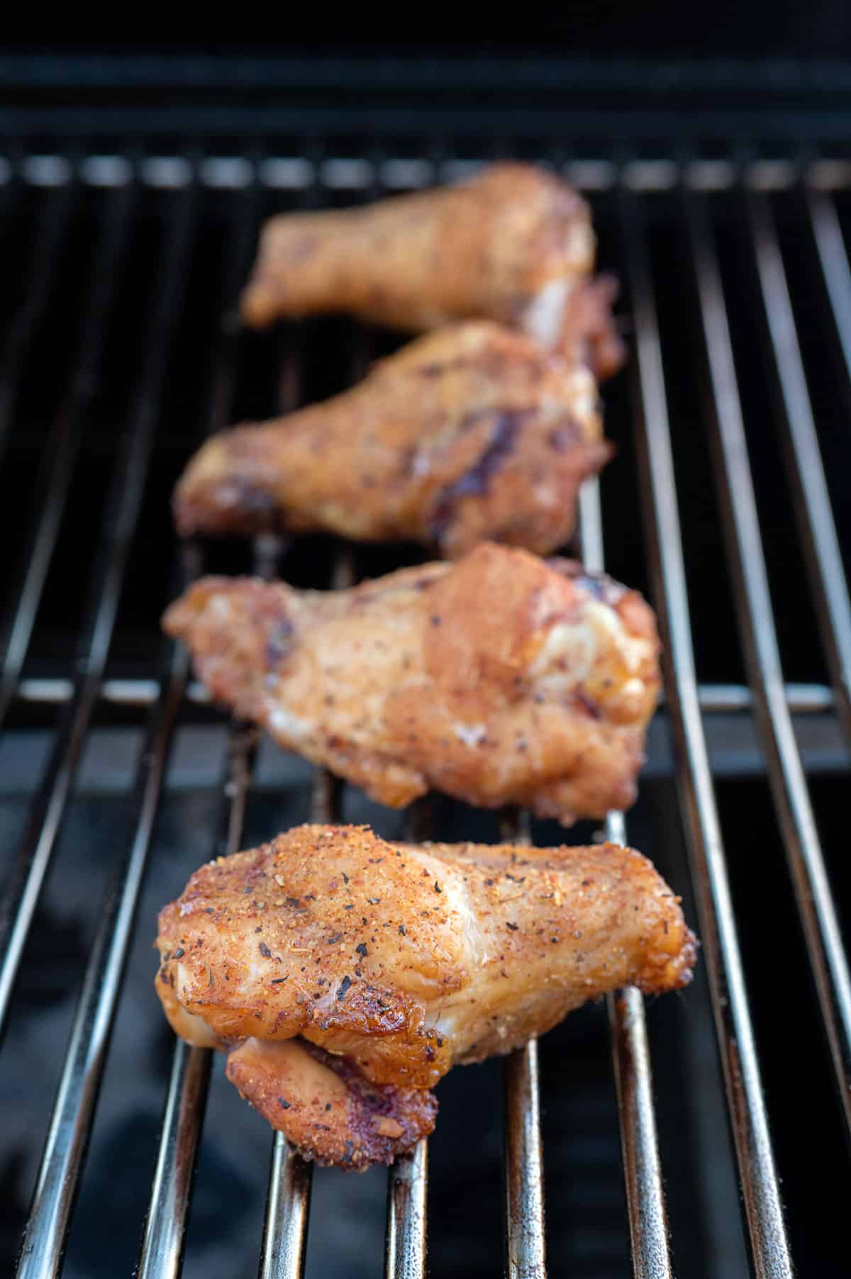 wings smoking on grill.