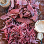 a pile of sliced and pulled beef brisket pastrami.