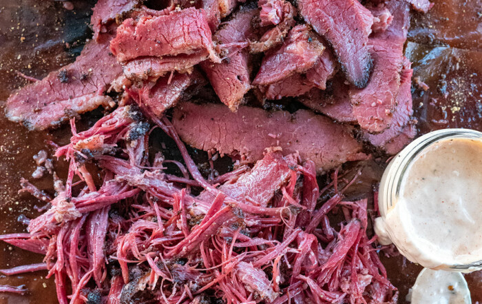 a pile of sliced and pulled beef brisket pastrami.