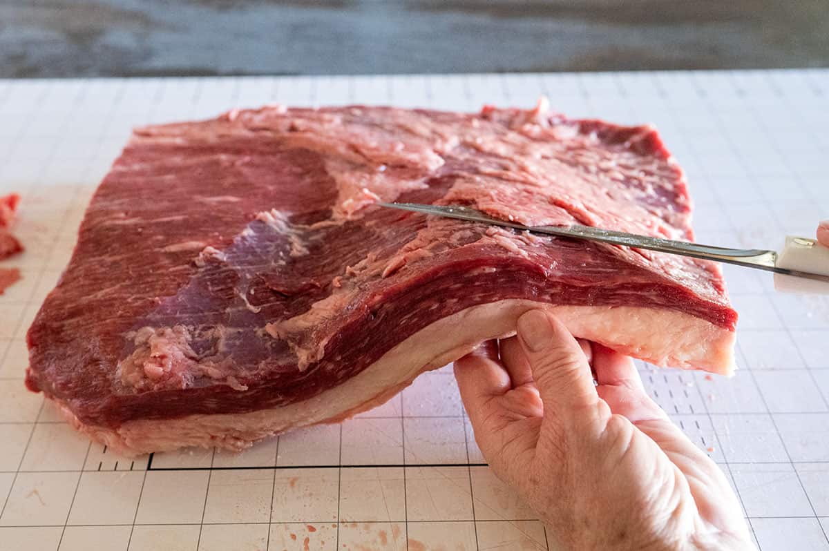 lifting brisket flat to remove silver skin.