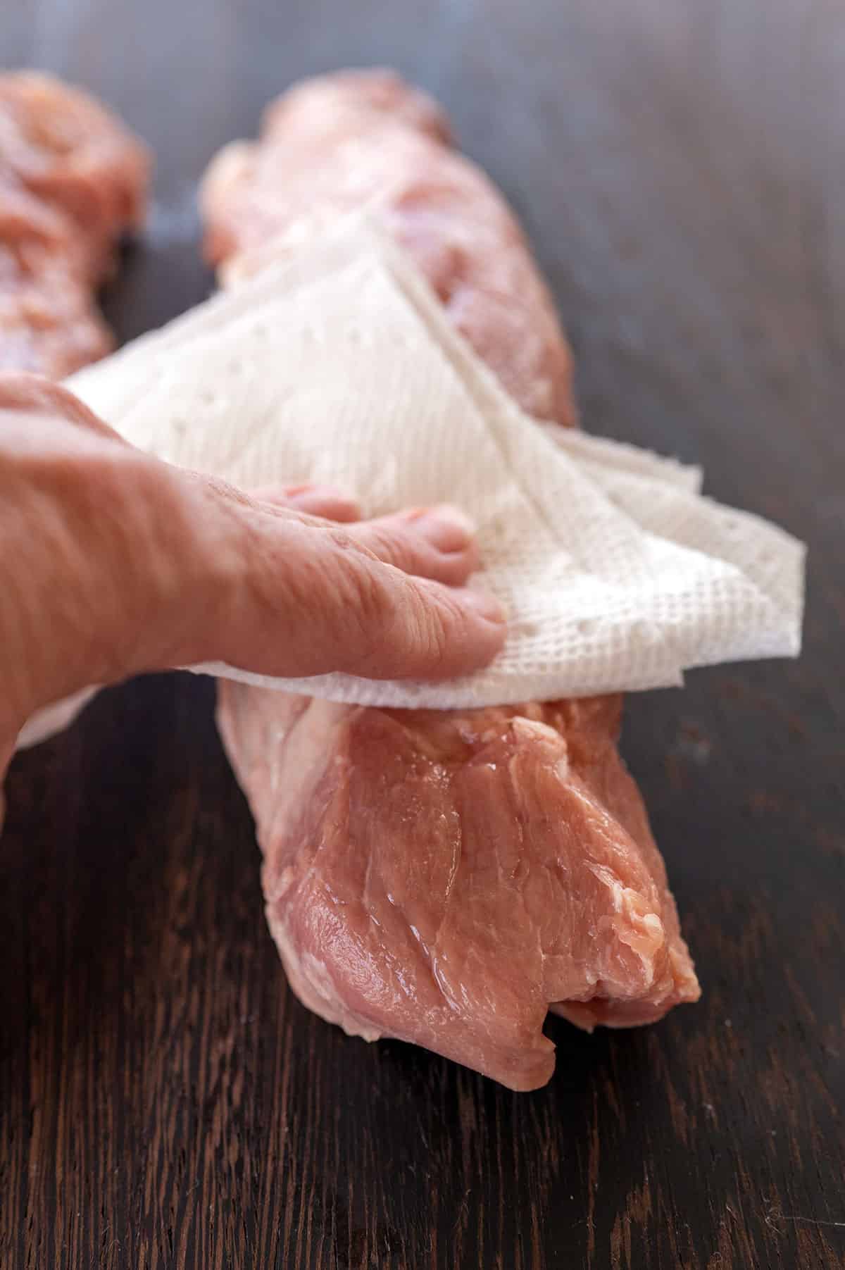patting pork tenderloin dry with paper towel.