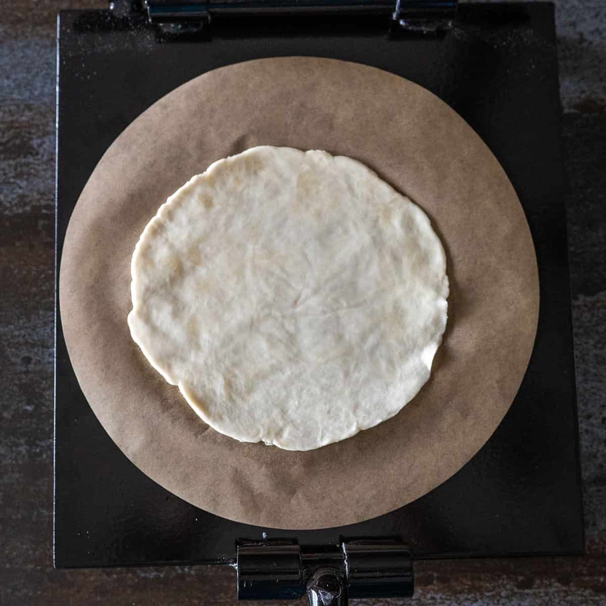 tortilla dough pressed flat.