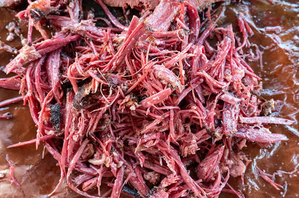 A pile of pulled beef pastrami.