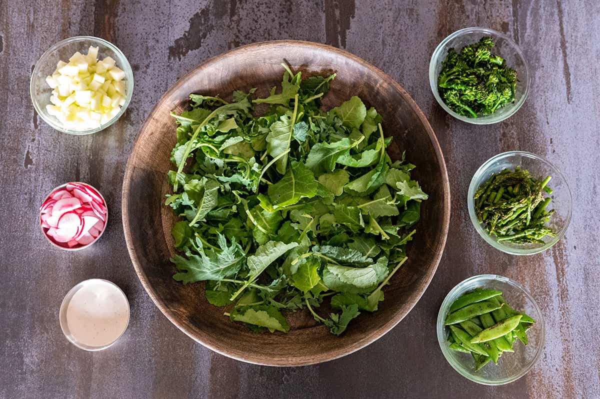 spring salad ingredients in bowls.