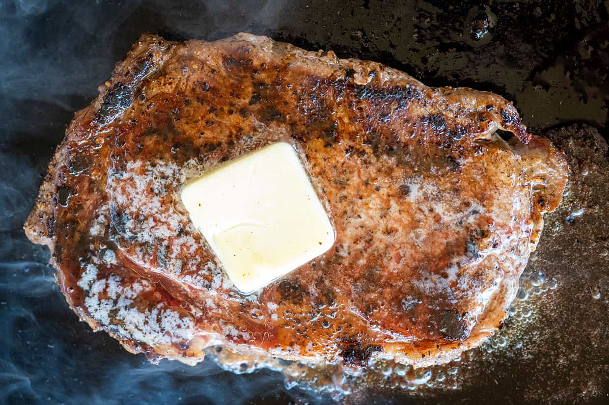 seared ribeye steak with melted butter on top.