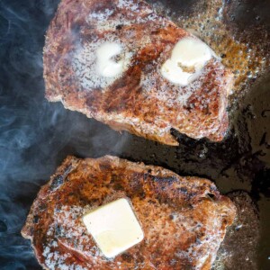 seared steaks topped with butter.