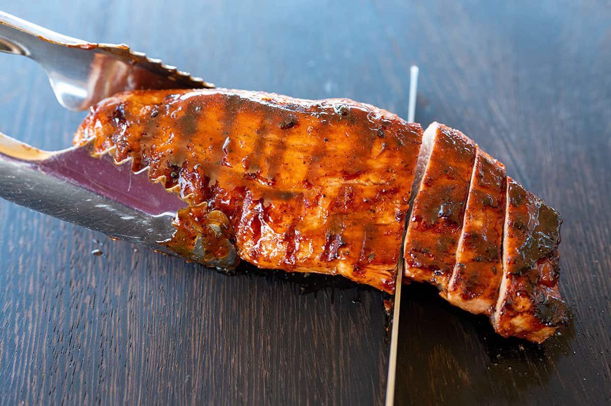slicing grilled pork tenderloin.