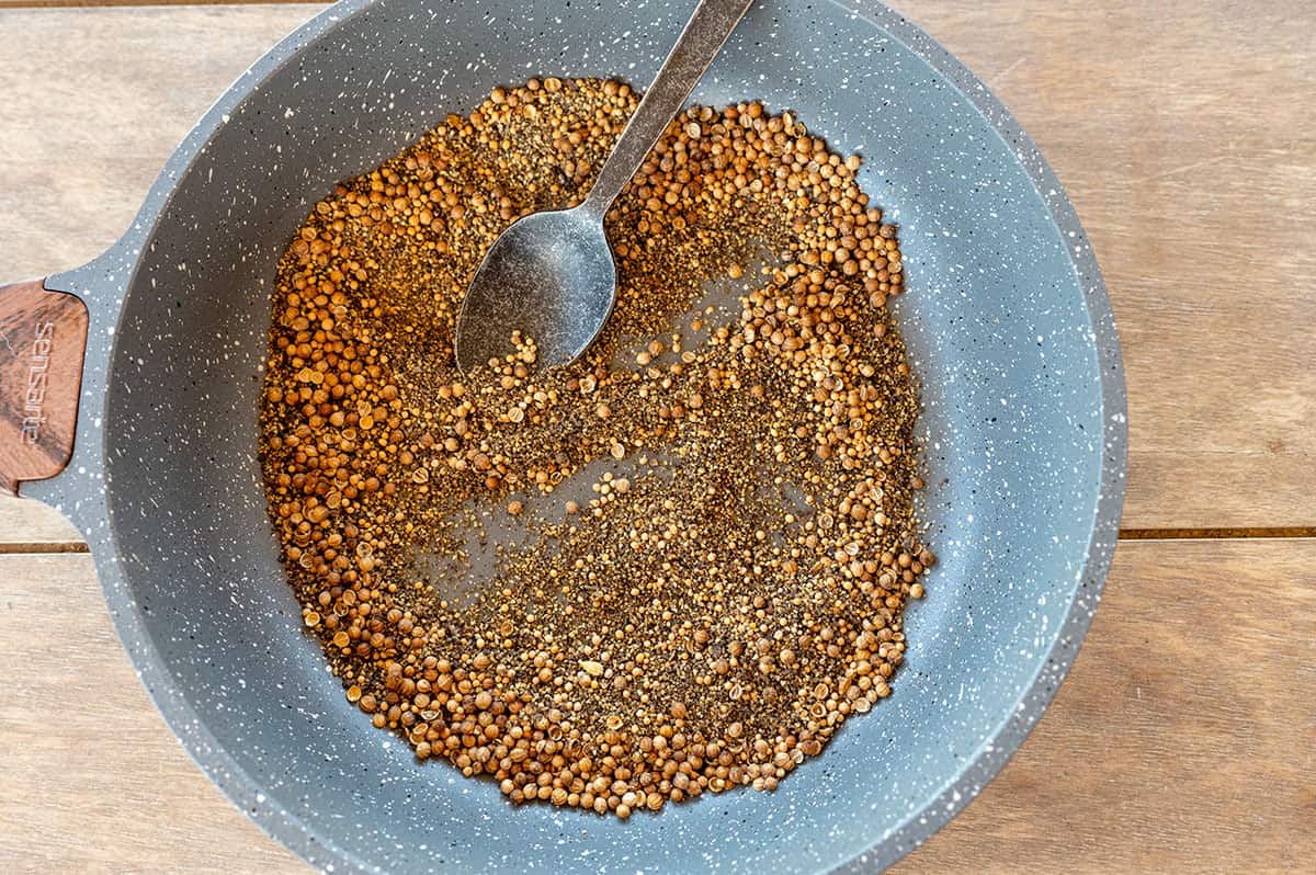 toasting mustard and coriander seeds and black pepper in pan.