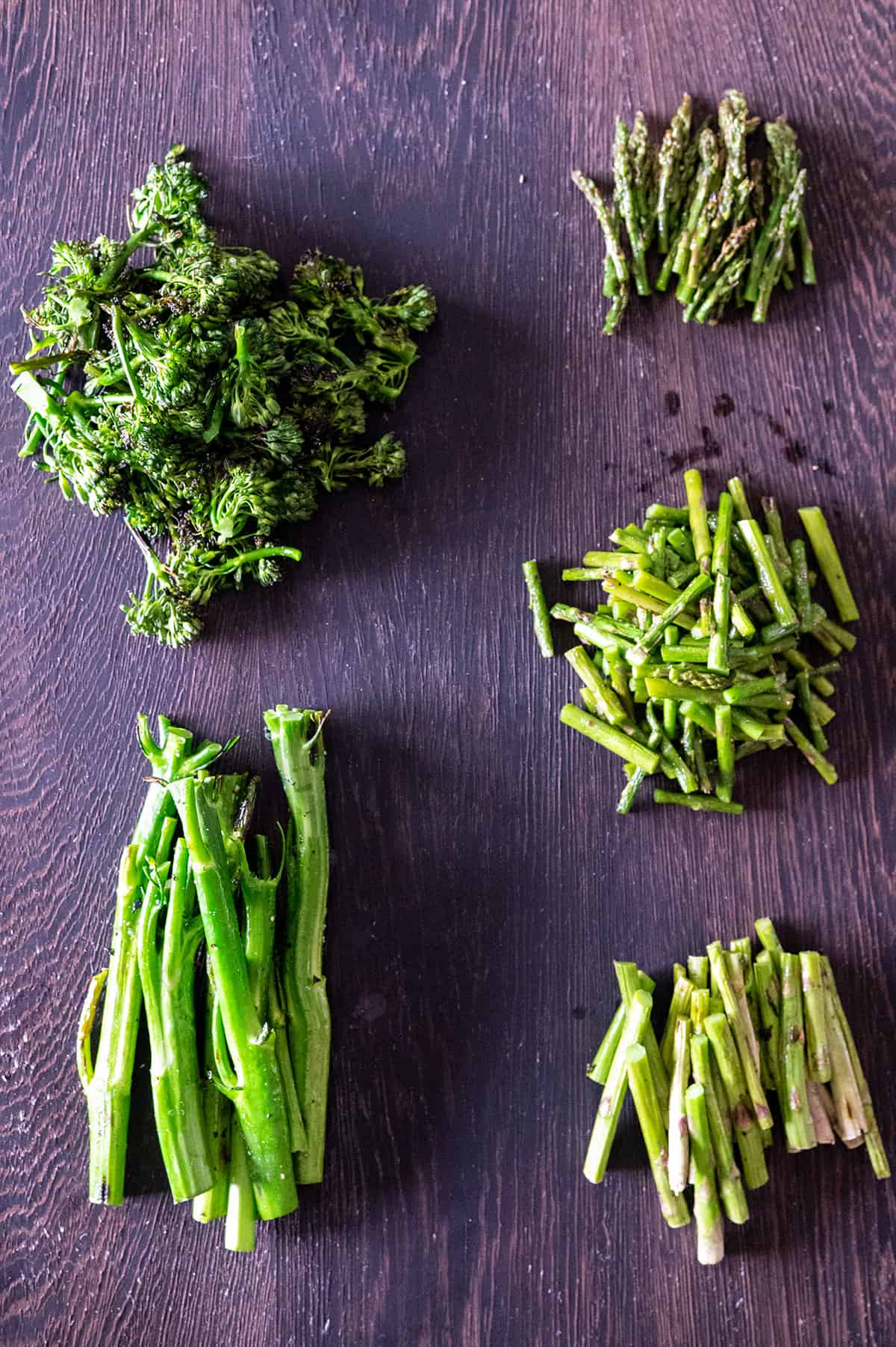 florets removed from broccolini and asparagus sliced with woody stems removed.