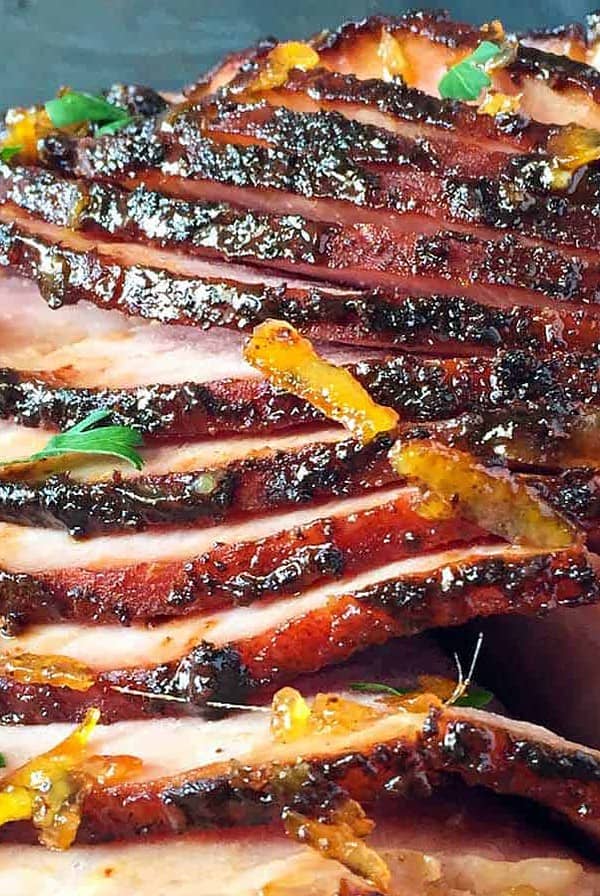 slices of grilled ham fanning out with orange mustard glaze.