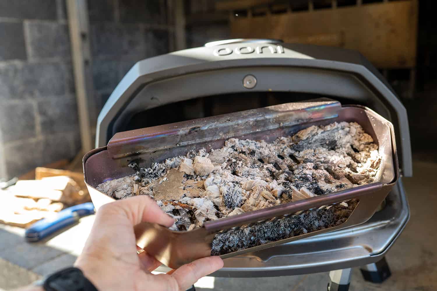 Removing ash from Ooni Pizza Oven.