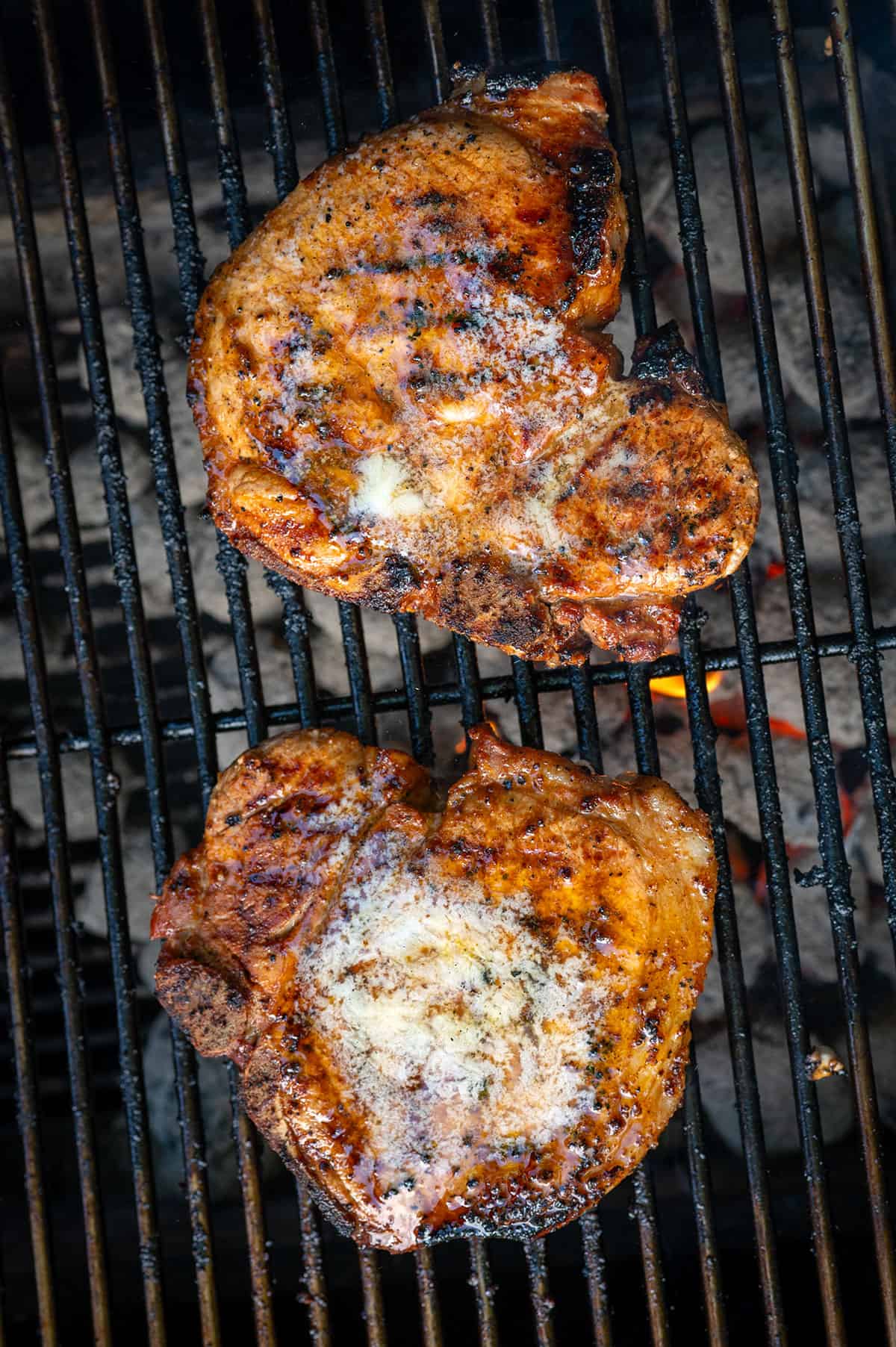 pork chops on grill with melted butter.