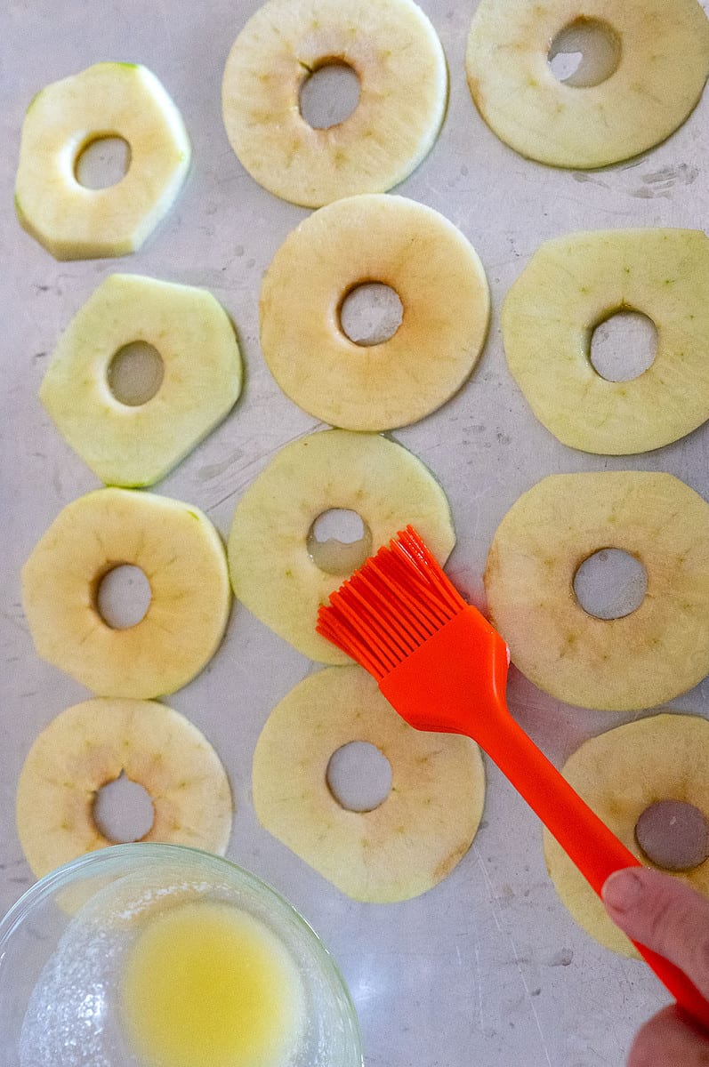 brushing apple slices with butter.