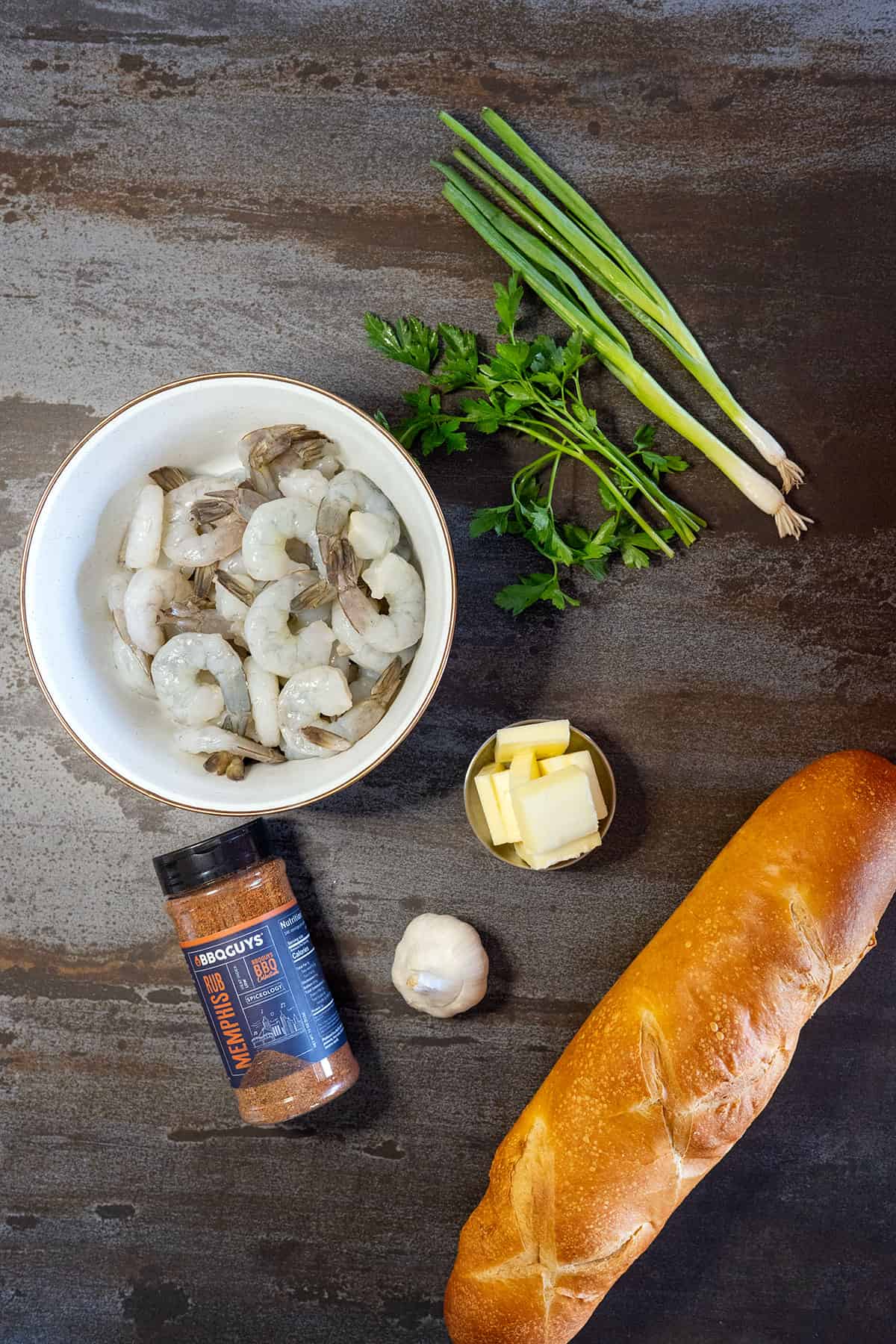 BBQ shrimp ingredients: shrimp, Memphis Rub, butter, garlic, bread, green onions, parsley.
